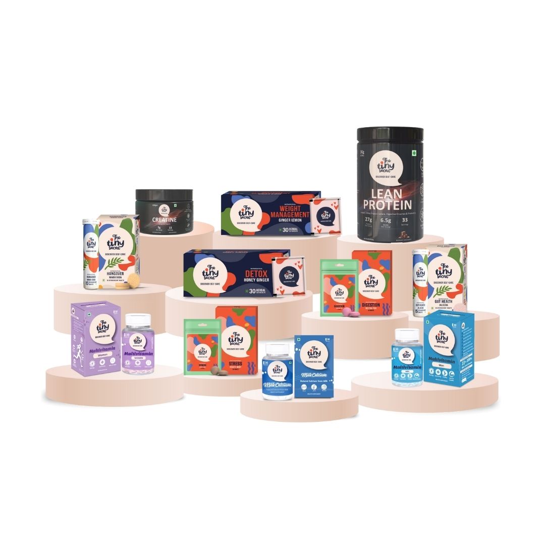 Assorted health and fitness products of The Tiny Secret on wooden stands with a white background